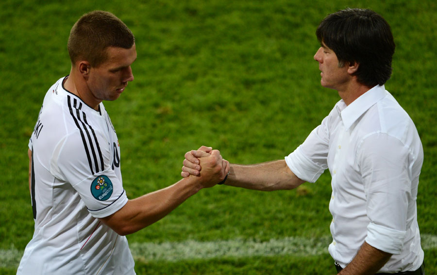Lukas Podolski shakes hands with Joachim Low