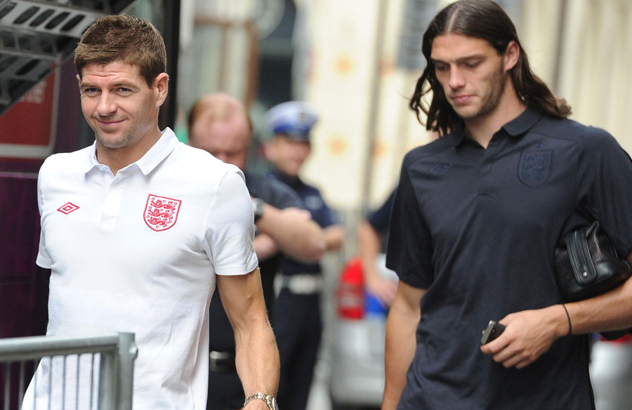 Steven Gerrard and Andy Carroll leave their team hotel for a training session