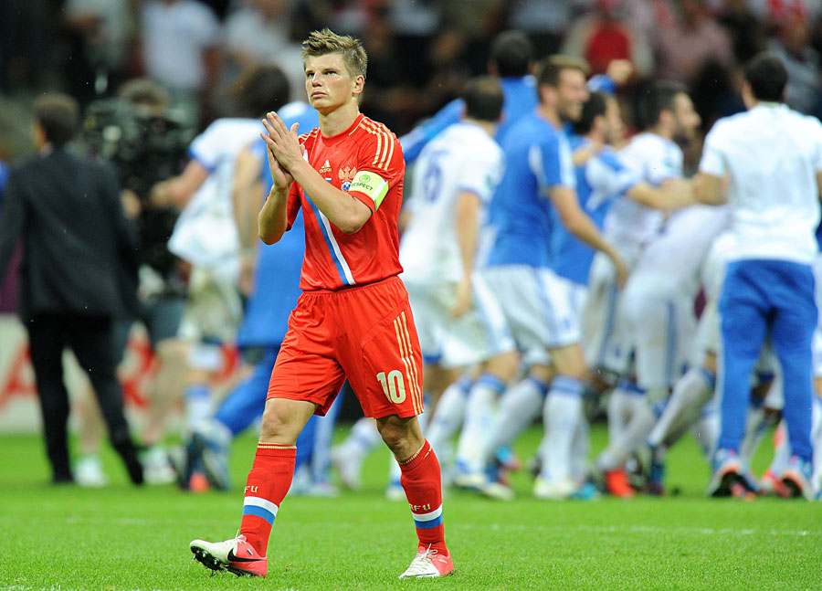 Russia's Andrey Arshavin applauds the Russian fans as he leaves the field of play dejected after the final whistle