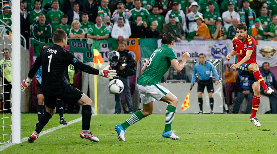 Spain's Cesc Fabregas scores his team's fourth goal past Ireland's Keith Andrews and goalkeeper Shay Given