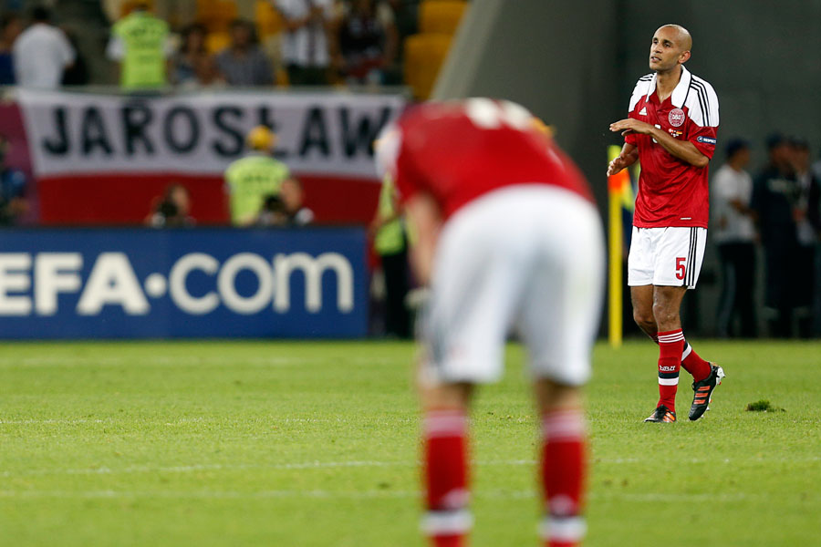 Denmark's players react after they crashed out of Euro 2012