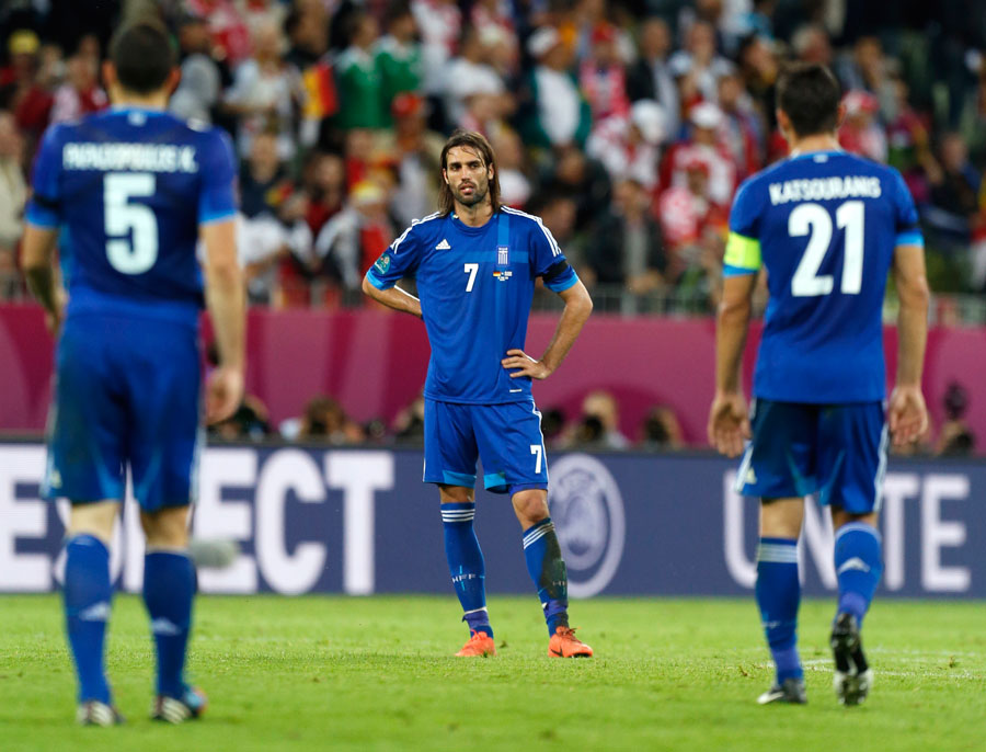 Greek players stand dejected as they went out
