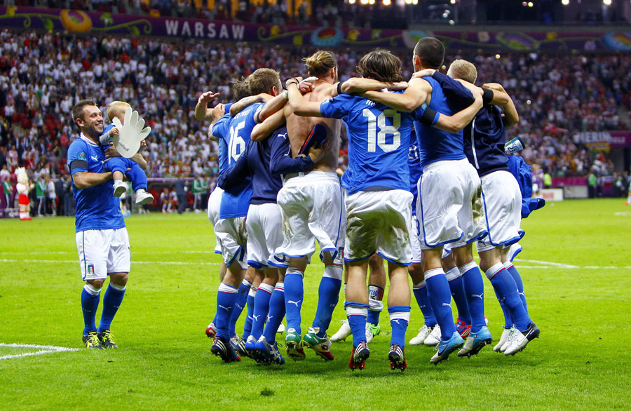 Germany's Mats Hummels looks dejected as Italy's goalkeeper Gianluigi Buffon and Andrea Barzagli celebrate