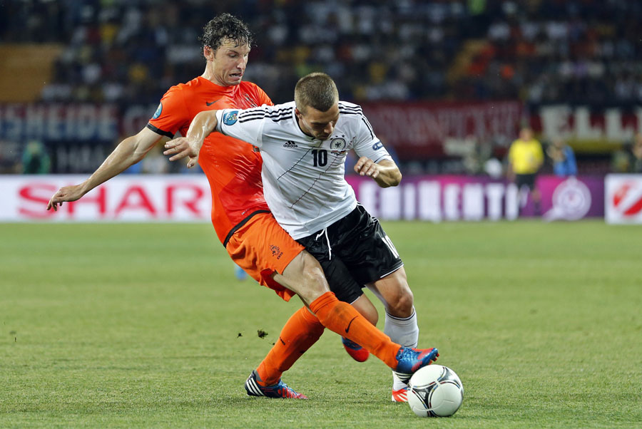Mark van Bommel tackles Lukas Podolski