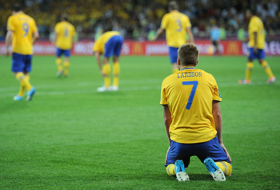 Sebastian Larsson of Sweden sits dejected after they were knocked out