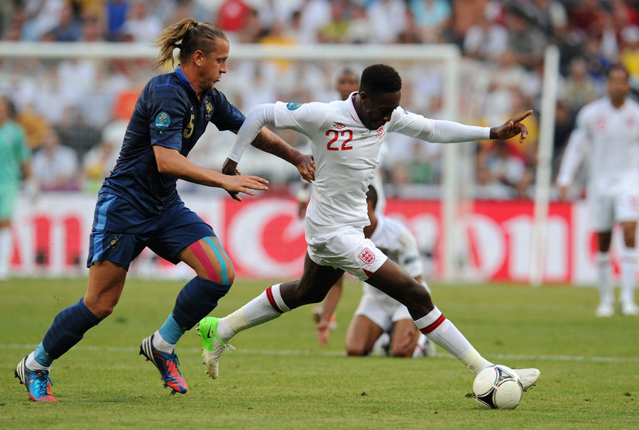 Danny Welbeck strides away from Philippe Mexes