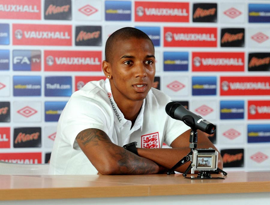 Ashley Young talks during a press conference