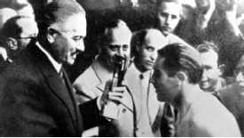 Giuseppe Meazza receives the Jules Rimet trophy after the 1938 success
